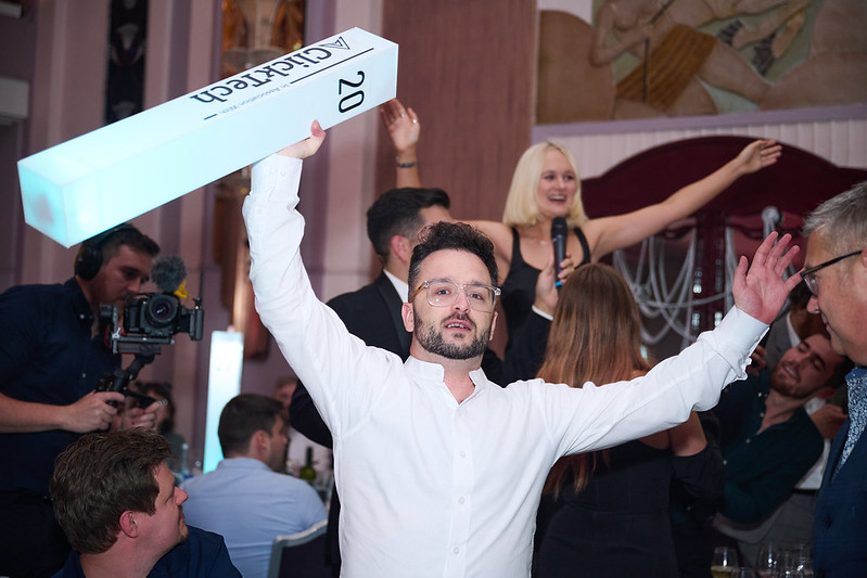 Man celebrating an award win with branding